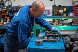 150908RotrexWinches-1215_300dpi Person in blue overalls repairing a winch